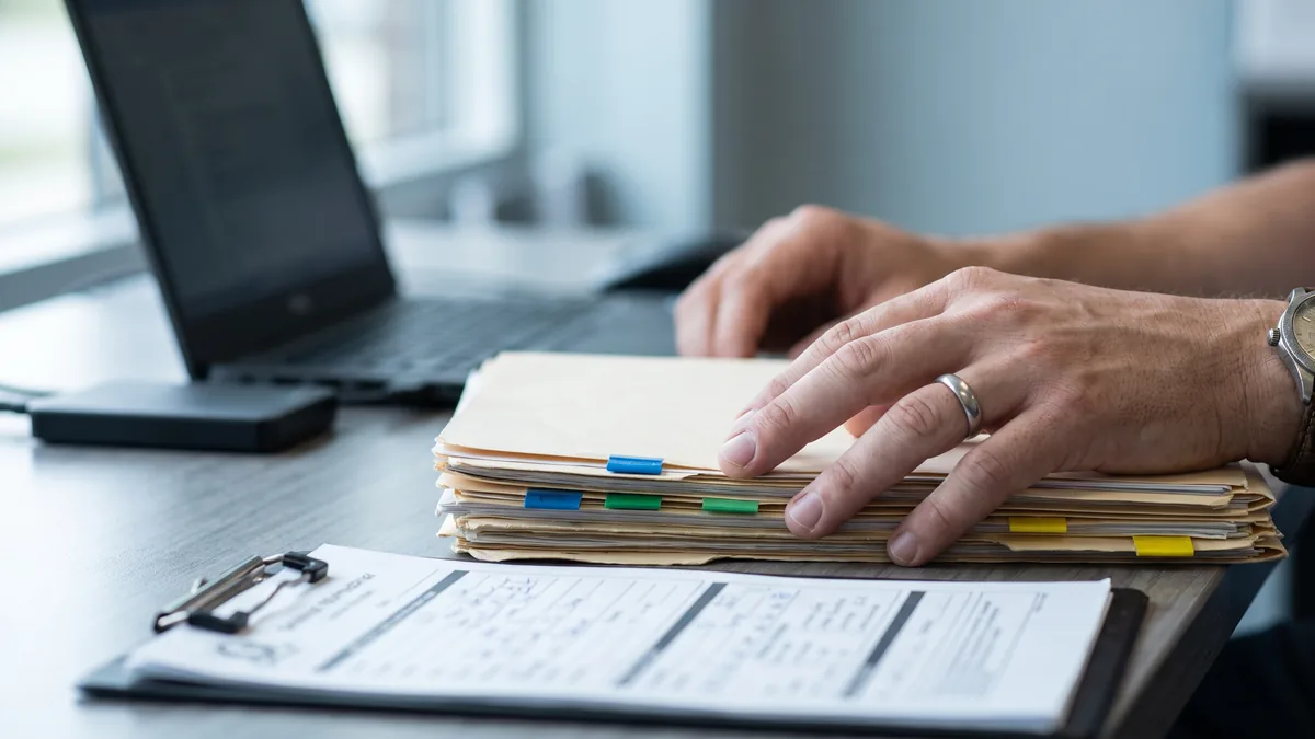Front desk reviewing patient records and files before migrating